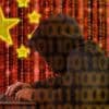 Chinese hacker in front of digital China flag showing state-sponsored cyber espionage
