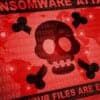 Skull and bones on screen showing ransomware attack on Swiss government provider