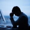 Stressed man in front of computer showing security operation center SOC