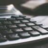 Calculator on table showing cost of data breach