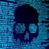 Computer code on screen with a skull showing ransomware attack and data breach
