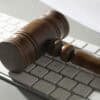 Gavel on keyboard showing privacy lawsuit on AI notetaker