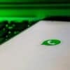 WhatsApp on mobile phone showing scam accounts