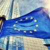 EU flag waving in front of European Parliament building showing chat control privacy violation