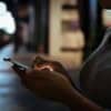 Close up of woman using phone showing data breach fine