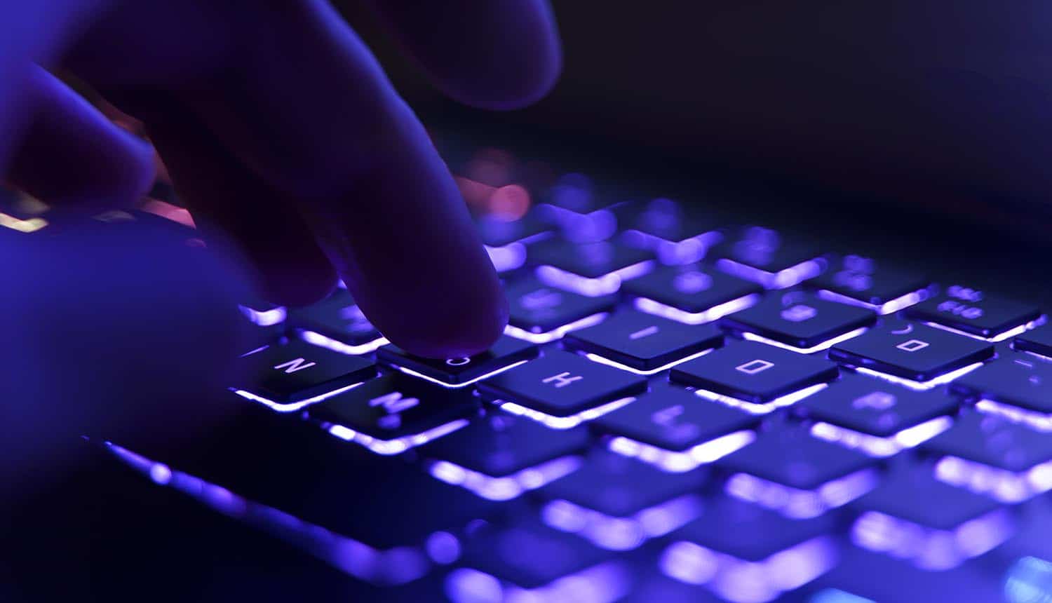 Fingers on a keyboard showing data breach at auction house
