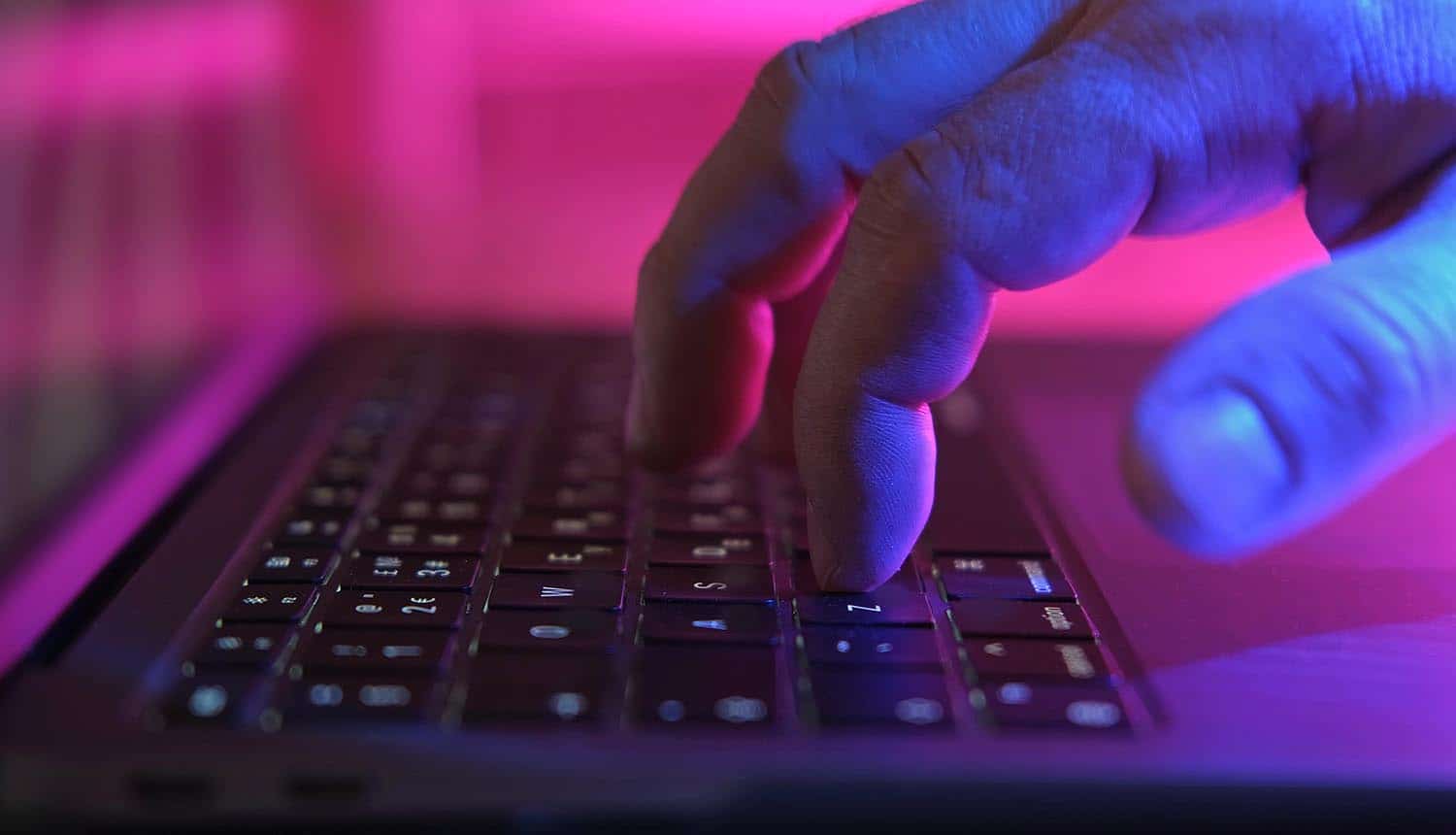 Hands typing on keyboard showing data breach