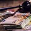 Hammer gavel and Euro money showing GDPR fine for credit rating agency