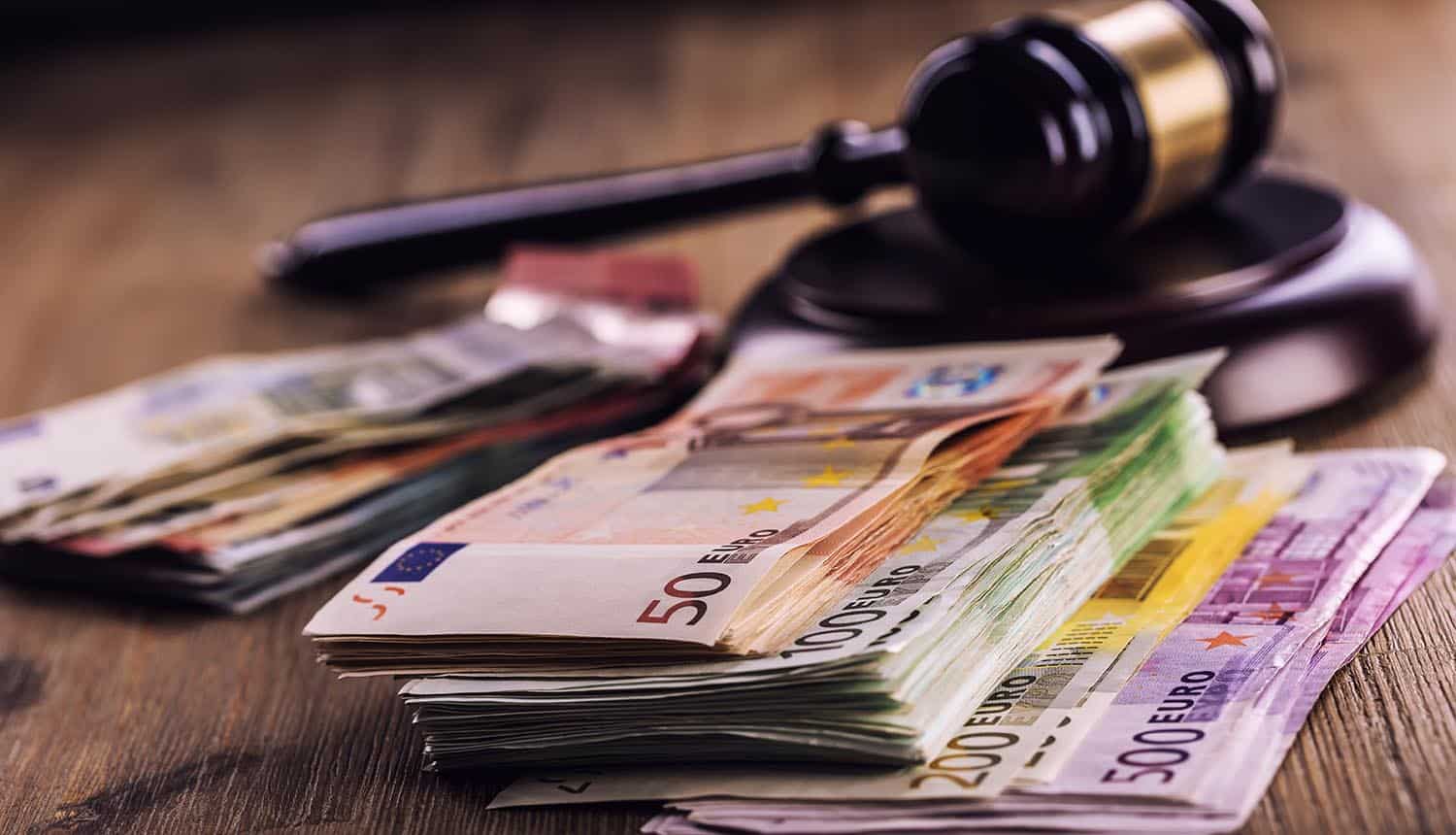 Hammer gavel and Euro money showing GDPR fine for credit rating agency