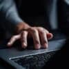 Man working on laptop showing cyber attack on Japanese brewer