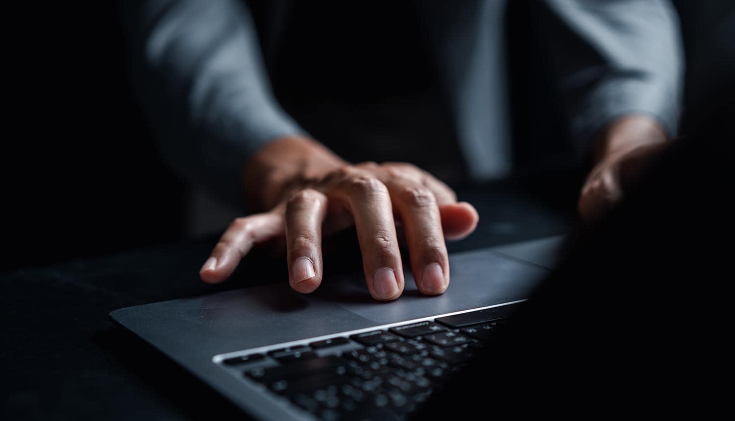 Man working on laptop showing cyber attack on Japanese brewer