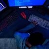 Hacker working on computer showing security breach affected customer data