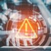 Hacker using laptop showing redis critical vulnerability with RCE