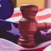 Hammer and US flag showing government contractor data breach