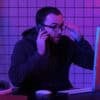 Hacker talking on the phone showing bank staff impersonated in account takeover