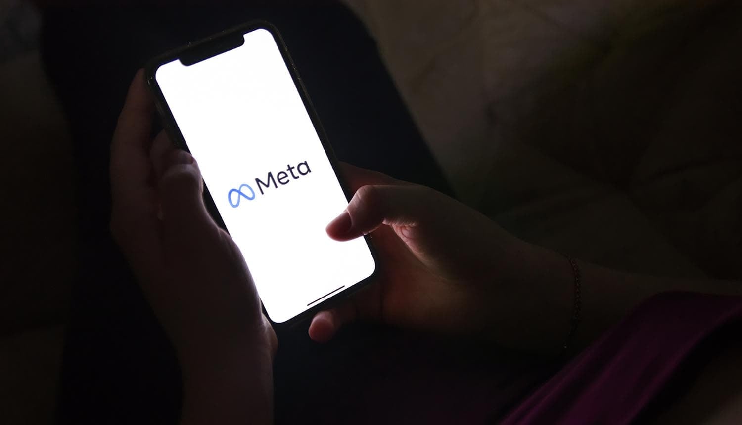 Phone with Meta logo showing privacy compliance staff replaced by AI