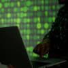 Hacker on laptop showing data breach of online retailer