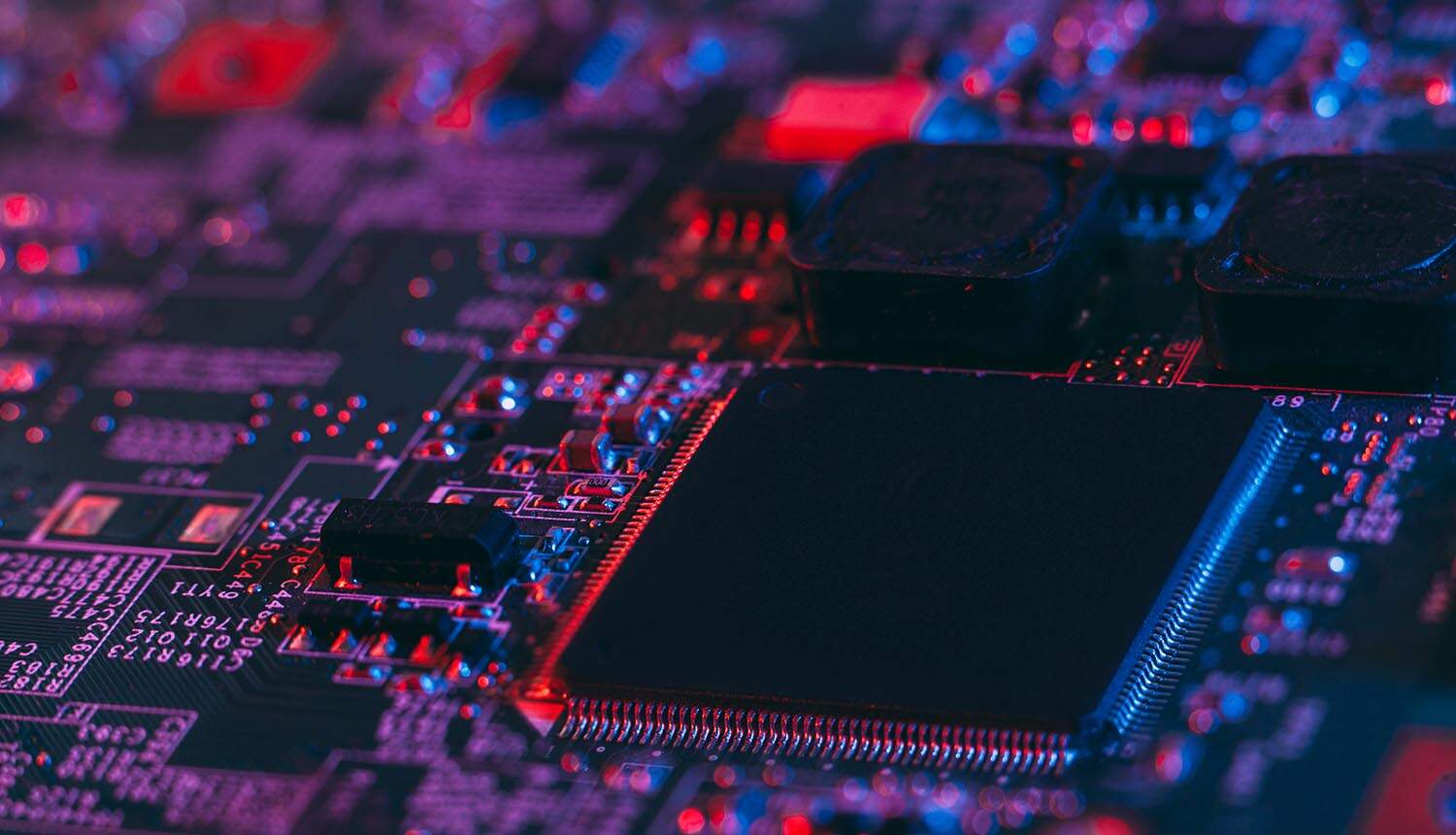 Motherboard in blue-red light showing data breach at manufacturing firm