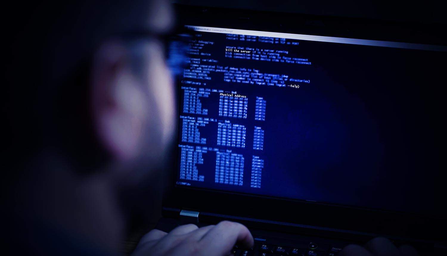 Hacker in glasses showing data breach at fintech