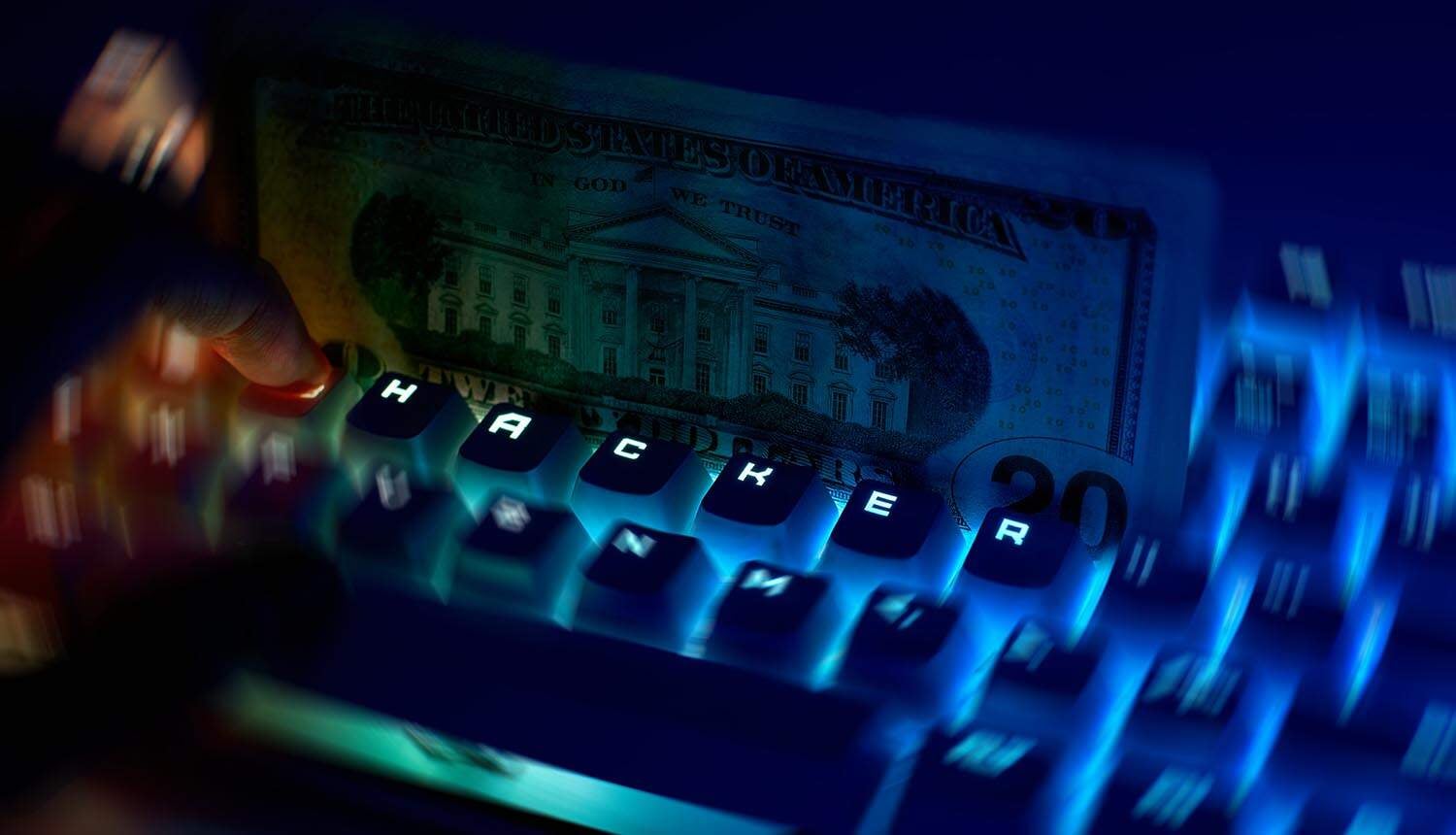 Computer keyboard with dollar notes showing fraud and AI