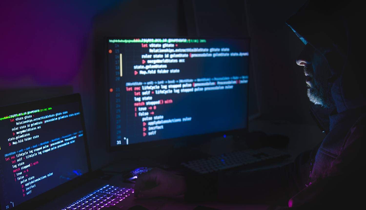 Hacker using laptop showing cyber attack by ransomware agang