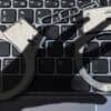 Handcuffs lying on keyboard showing law enforcement on scam accounts