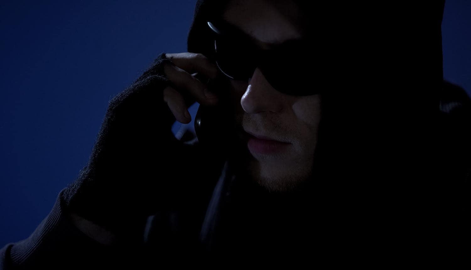 Hacker on the phone showing vishing attack on ad tech firm