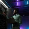 Engineer working in data center showing patch management