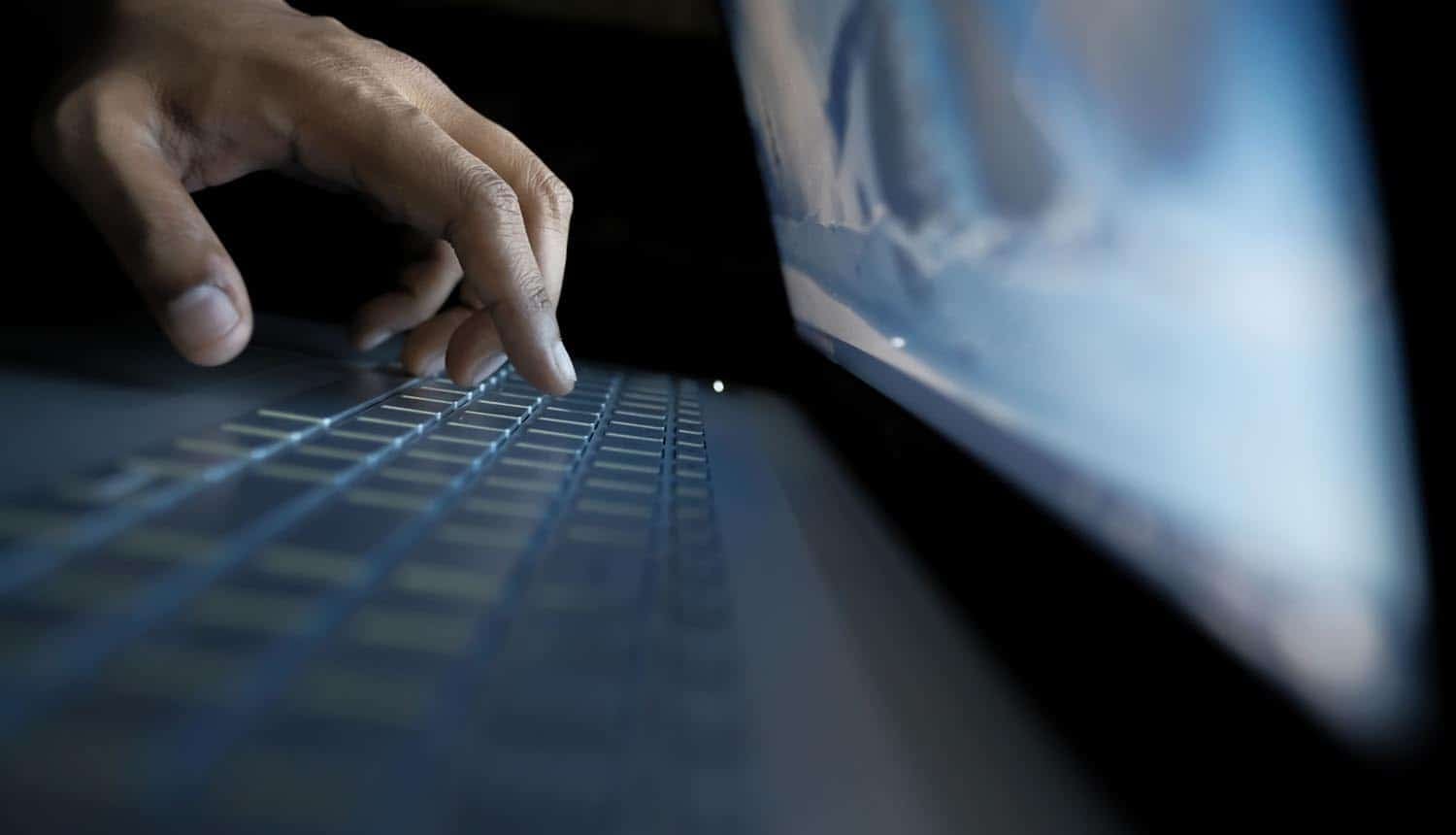 Hands on laptop showing data theft of social security data
