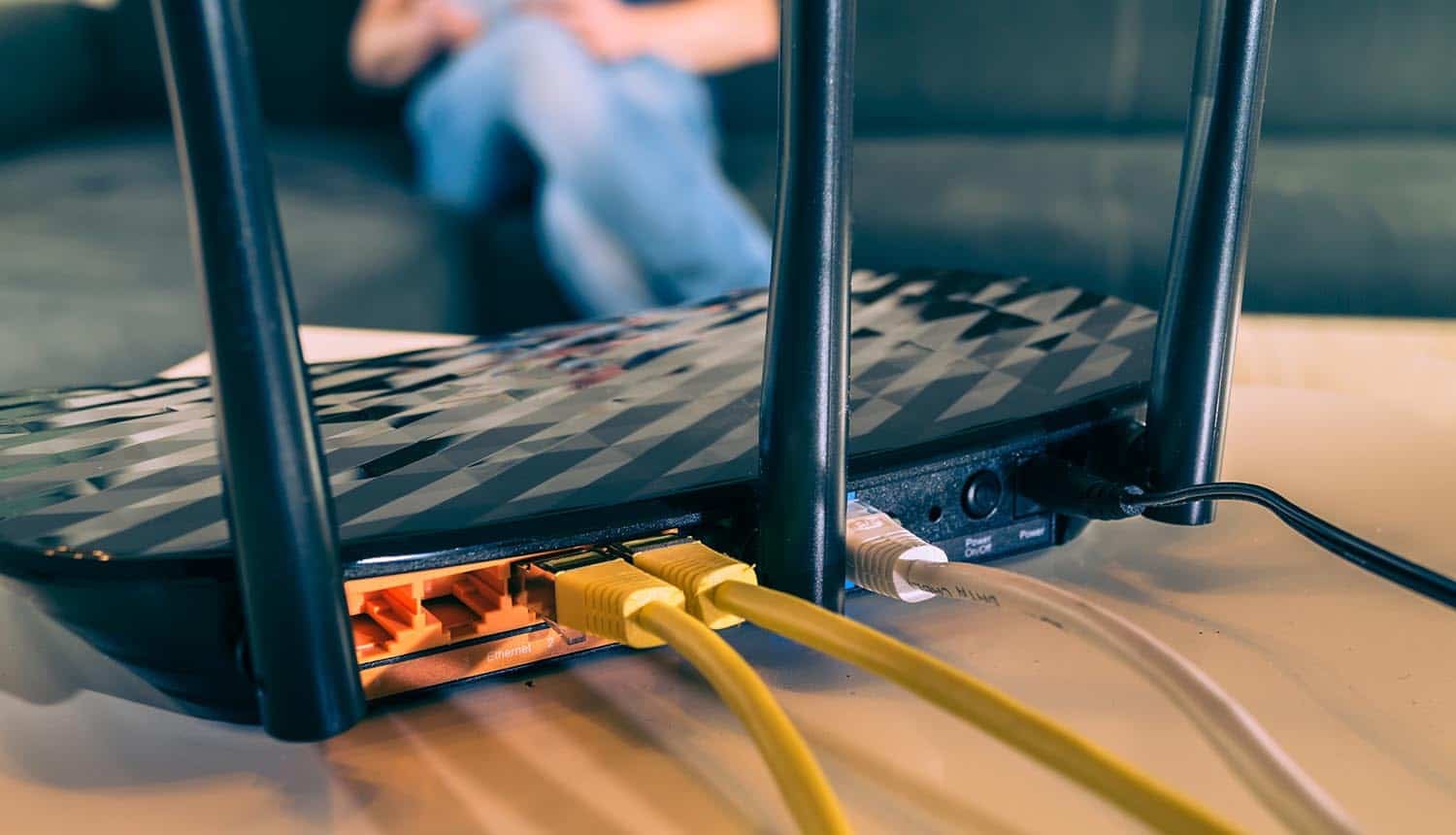 Wireless router with connected cables showing Russian hackers DNS hijacking and credential theft