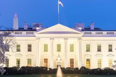 White House at twilight showing operating budget cuts for CISA