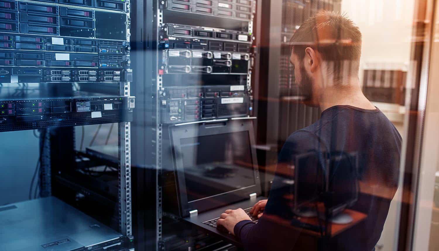 Engineer in data center showing network admin