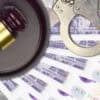 British pounds bills and judge hammer showing data breach of water supplier