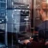IT engineer working in data center showing critical vulnerabilities remediation