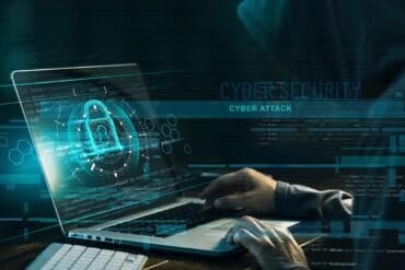 Hacker working on code showing data breach