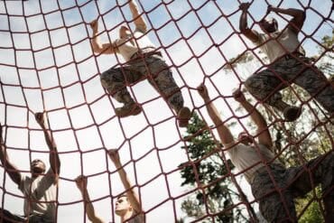 Military soldiers climbing rope showing location data