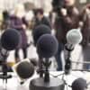 Microphones against journalists showing fake data breach notice