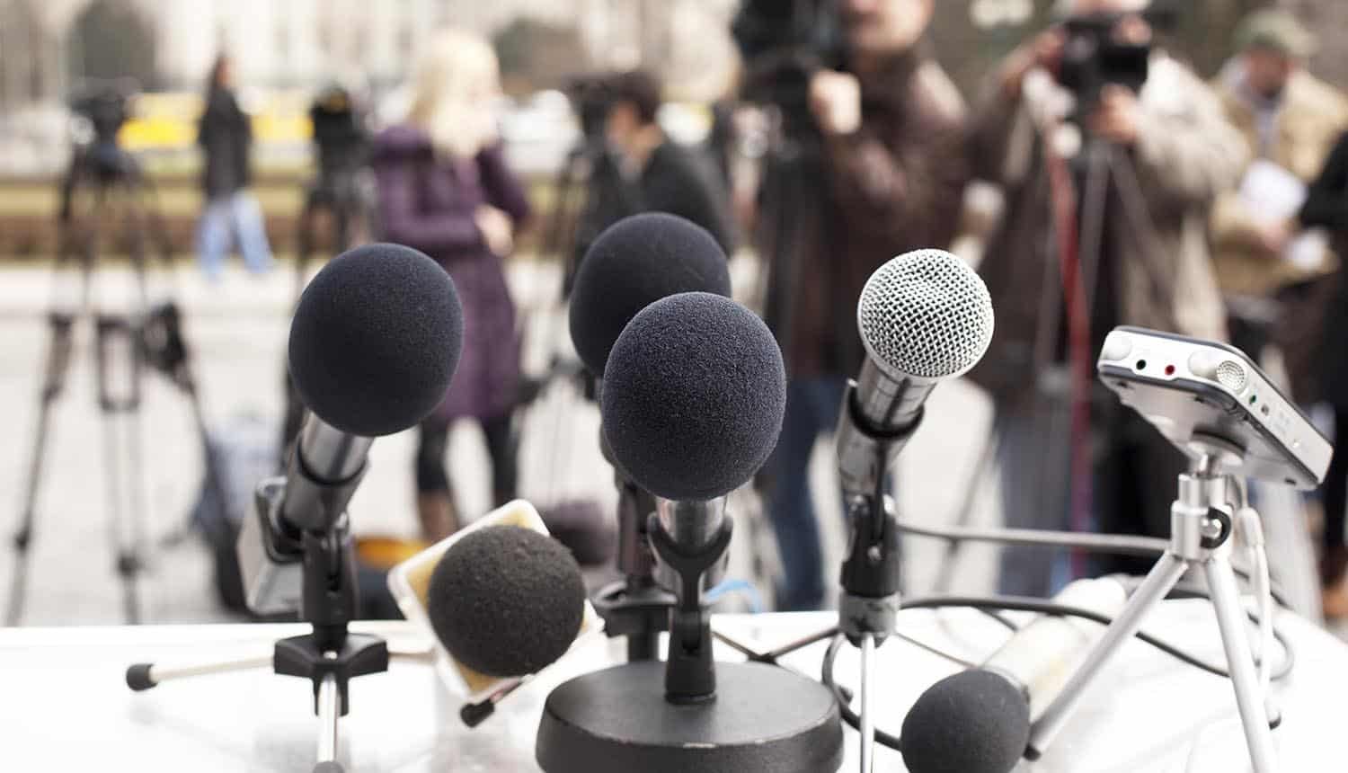 Microphones against journalists showing fake data breach notice