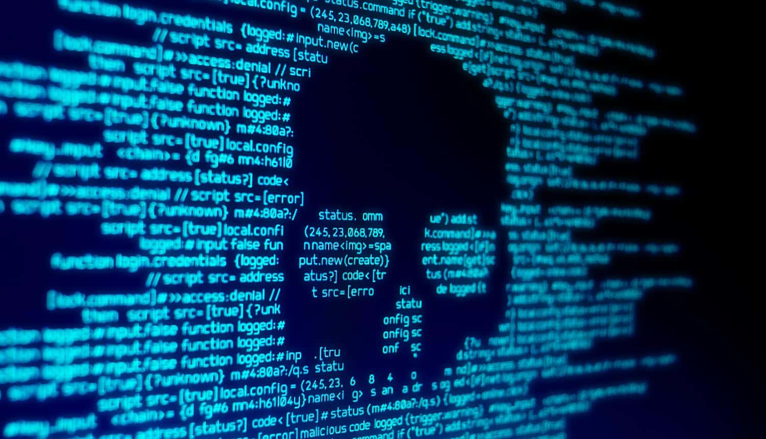 Code on screen with skull showing ransomware attack