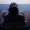 Hacker at laptop showing critical infrastructure exploited by Russian hackers