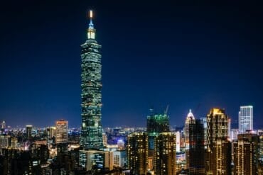 Taipei skyline at night showing autonomous AI cyber attack by Chinese hackers