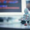 Toy robot on table showing AI models