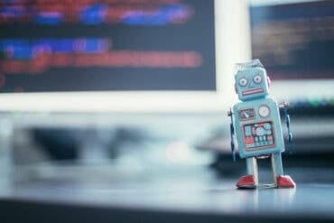 Toy robot on table showing AI models