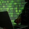 Hacker with laptop showing ransomware gang