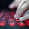 Hand on keyboard showing cyber attack on data services