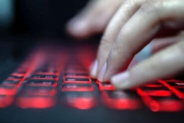 Hand on keyboard showing cyber attack on data services