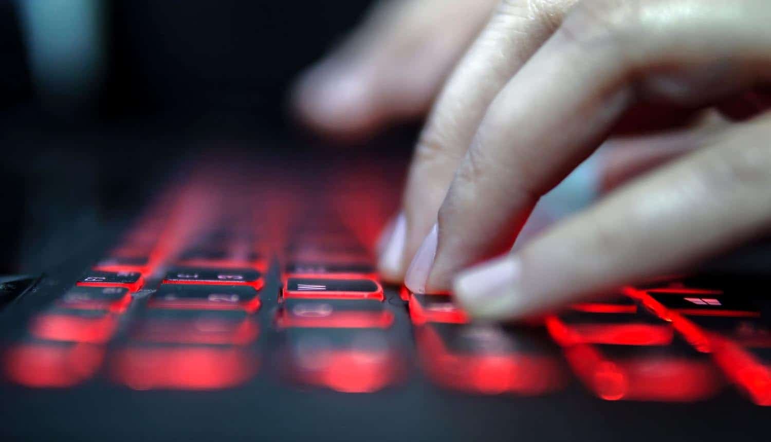 Hand on keyboard showing cyber attack on data services