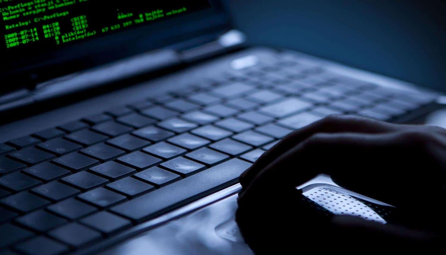 Hand on laptop showing LiteLLM supply chain attack