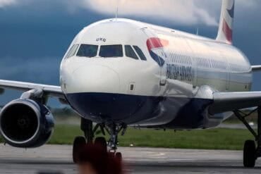 Plane on runway showing cyber attack on UK airports