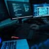 Hacker working on computer showing cyber attack caused operational disruption